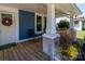 Front porch with wood flooring, white columns, and potted plants at 1318 W Wilson Lee Blvd, Statesville, NC 28677