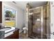 Bathroom with walk-in shower, granite vanity, and large window at 240 S Center St, Taylorsville, NC 28681