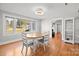 Bright dining room with hardwood floors, an oval table and view to the living room at 240 S Center St, Taylorsville, NC 28681