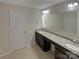 Main bathroom with double vanity, granite countertops, and a bathtub at 8103 Mossy Rock Rd, Waxhaw, NC 28173