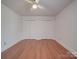 Bright bedroom with hardwood floors and double closets at 909 Woodhurst Dr, Monroe, NC 28110