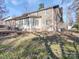 Back of house with sunroom addition and patio at 909 Woodhurst Dr, Monroe, NC 28110