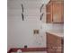 Laundry room with wire shelving and built-in cabinets at 909 Woodhurst Dr, Monroe, NC 28110