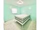 Bedroom with light teal walls, carpet, and a white bed frame at 2223 Chatham St, Newton, NC 28658