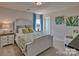 Bright bedroom with a queen bed, nightstands, and artwork at 132 Balboa St, Matthews, NC 28104