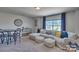 Spacious bonus room with a sectional sofa and a dining table at 132 Balboa St, Matthews, NC 28104
