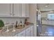 Kitchen boasts granite countertops, white cabinets, and stainless steel appliances at 132 Balboa St, Matthews, NC 28104