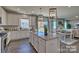 Open concept kitchen with granite island, white cabinets, and a view to the backyard at 132 Balboa St, Matthews, NC 28104
