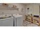 Laundry room with washer, dryer, and built-in shelving at 132 Balboa St, Matthews, NC 28104