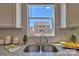 Kitchen features granite countertops, a double sink, and a view of the backyard at 132 Balboa St, Matthews, NC 28104