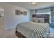 Secondary bedroom with striped bedding and rustic wood headboard at 132 Balboa St, Matthews, NC 28104