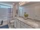 Bathroom with granite countertop, double sinks, and a shower/tub combo at 132 Balboa St, Matthews, NC 28104