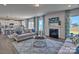 Comfortable living room with fireplace, large windows, and a neutral color palette at 132 Balboa St, Matthews, NC 28104