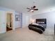 Well-lit bedroom with a king-size bed and ensuite bathroom at 4074 Town Center Rd, Harrisburg, NC 28075