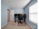 Spacious home office featuring a large desk and comfortable office chair at 4074 Town Center Rd, Harrisburg, NC 28075