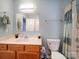 Clean bathroom with tub, shower, and wood vanity at 4074 Town Center Rd, Harrisburg, NC 28075