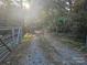 Gravel driveway entrance with metal gate at 5101 Goldmine Rd, Monroe, NC 28110