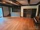 Gathering room with hardwood floors, built-in bar, and shelving at 5101 Goldmine Rd, Monroe, NC 28110