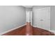 Spacious bedroom with hardwood floors and double doors leading to hallway at 3157 Delaware Dr, Denver, NC 28037