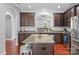 Spacious kitchen with granite countertops, island, and dark brown cabinets at 3157 Delaware Dr, Denver, NC 28037