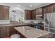 Spacious kitchen with dark cabinets, granite countertops, and stainless steel appliances at 3157 Delaware Dr, Denver, NC 28037