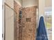 Shower with tile surround and built-in shower caddy at 3157 Delaware Dr, Denver, NC 28037