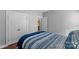 Bright bedroom with hardwood floors and double doors leading to a bathroom at 3157 Delaware Dr, Denver, NC 28037