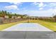 Large backyard with basketball court, fire pit, and plenty of grass space at 3157 Delaware Dr, Denver, NC 28037