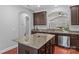 Modern kitchen with dark cabinets, granite countertops, and island at 3157 Delaware Dr, Denver, NC 28037