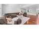 Open living room featuring hardwood floors, a sectional sofa, and a view into kitchen at 3157 Delaware Dr, Denver, NC 28037