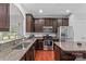 Modern kitchen with granite countertops, stainless steel appliances, and dark wood cabinets at 3157 Delaware Dr, Denver, NC 28037