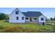 White farmhouse style home with gray roof and brick base at 615 Sandycrest Dr, Cherryville, NC 28021