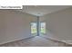 Bright bedroom featuring neutral walls and two large windows at 8066 Kennesaw Dr, Gastonia, NC 28056