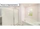 Relaxing bathroom with shower and bathtub, plus a window at 7759 Woolsey Dr, Gastonia, NC 28056