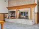 Basement fireplace with brick surround and wood storage at 502 Downing Dr, Kings Mountain, NC 28086