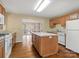 Kitchen with oak cabinets, an island, and hardwood floors at 502 Downing Dr, Kings Mountain, NC 28086