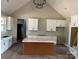 Modern kitchen with white cabinets and large island at 615 Sandycrest Dr, Cherryville, NC 28021