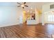 Open living room with hardwood floors, kitchen island and vaulted ceilings at 17228 Hampton Trace Rd, Huntersville, NC 28078