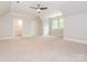 Spacious bedroom with carpet, ceiling fan, and ensuite bathroom access at 1709 Brookshaw Run, Fort Mill, SC 29715