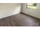 Empty bedroom featuring wood-look flooring and a large window at 1831 J Julian Ln # A, Charlotte, NC 28208