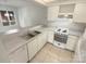 White kitchen with an electric range and a double sink at 1831 J Julian Ln # A, Charlotte, NC 28208