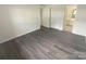 Bright bedroom with grey laminate flooring and access to bathroom and closets at 1831 J Julian Ln # A, Charlotte, NC 28208