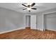 Bright bedroom with hardwood floors and ceiling fan at 508 Deese St, Monroe, NC 28112