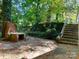 Rustic brick fireplace and steps leading up from a partially-covered patio area at 508 Deese St, Monroe, NC 28112