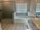 Elegant bathroom with soaking tub, shower, and double vanity at 177 Rhuidean Ct, Troutman, NC 28166