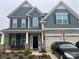 Two-story house with gray siding, stone accents, and a two-car garage at 177 Rhuidean Ct, Troutman, NC 28166