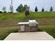 Built-in outdoor kitchen with grill and storage at 177 Rhuidean Ct, Troutman, NC 28166