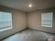 Well-lit bedroom with two windows and carpet flooring at 177 Rhuidean Ct, Troutman, NC 28166