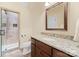 Bathroom with granite vanity, shower, and a large mirror at 18528 Nantz Rd, Cornelius, NC 28031