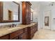 Elegant bathroom with double vanity, granite counters, and a large soaking tub at 18528 Nantz Rd, Cornelius, NC 28031